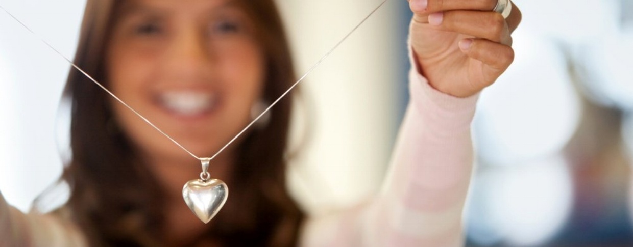Beautiful young woman with silver heart shaped necklace in her hand-629743-edited.jpeg
