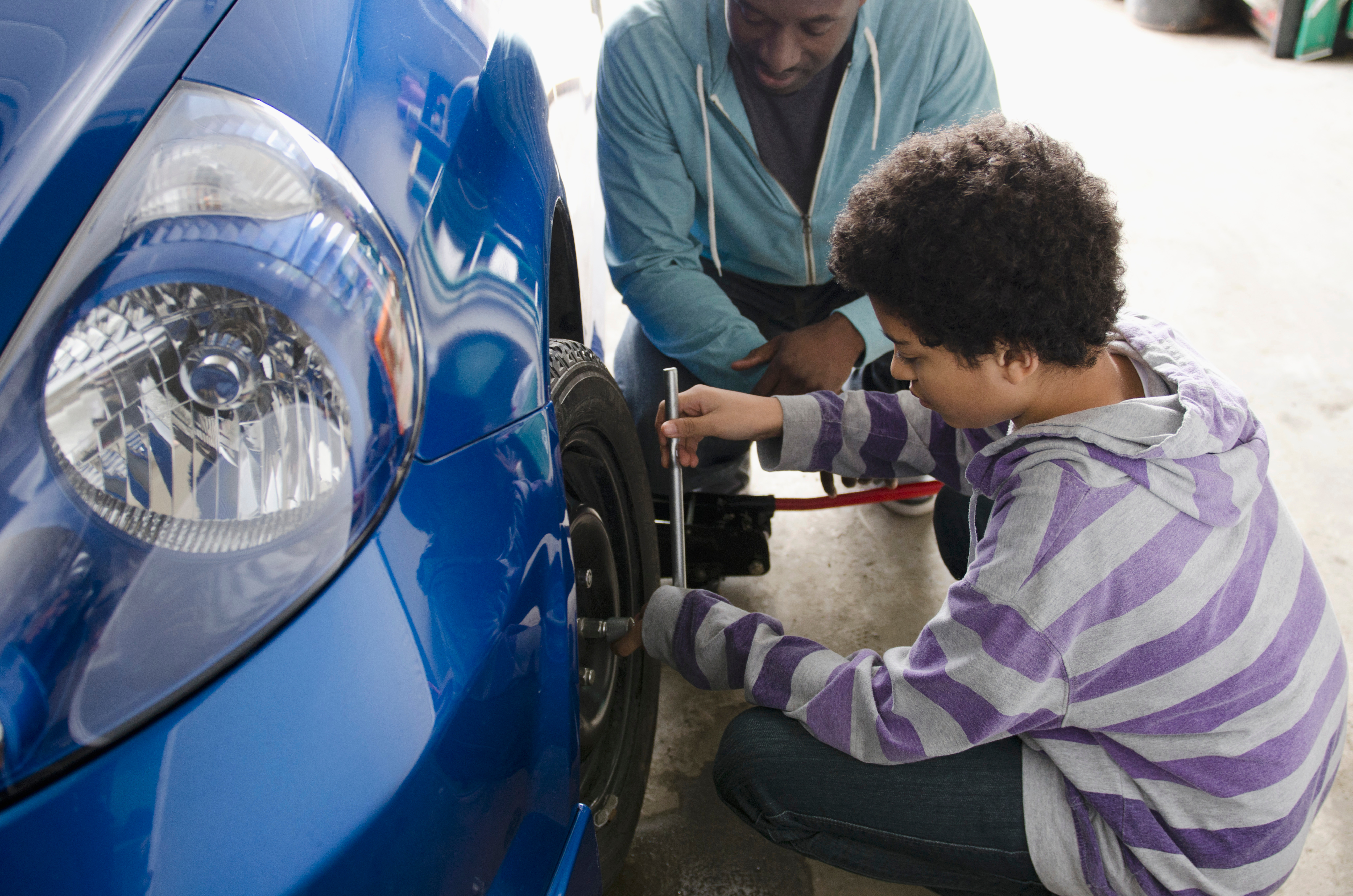 Teen learning life skills with car maintenance Teen learning life skills with car maintenance